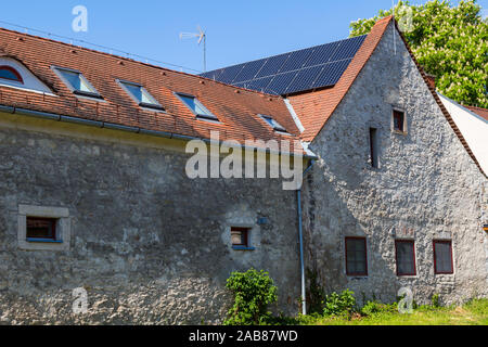 Vieille maison avec des panneaux solaires installés sur le toit Banque D'Images