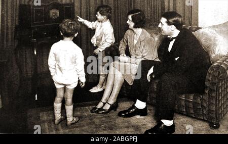 Au début de la télévision (1920) - de 30 ans une photo d'un groupe familial en regardant un début de Baird Televiser. La maison construite à balayage mécanique récepteur de télévision produit une photo à l'aide d'un métal en rotation ' Nipcow' disque avec trous dans lui, tandis que la lampe produit un balayage linéaire de 48 à d'abord produire une mauvaise image orange dim 1,5 pouces carré, à 7,5 images par seconde. Banque D'Images