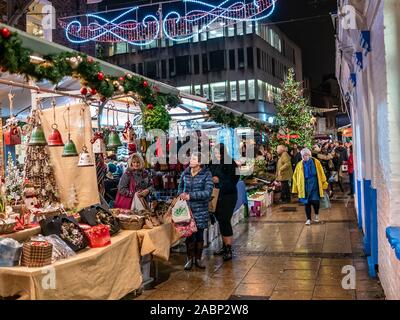 Visite des stands de fête Shoppers au Little Shambles fin du marché de Noël 2019 à York Banque D'Images