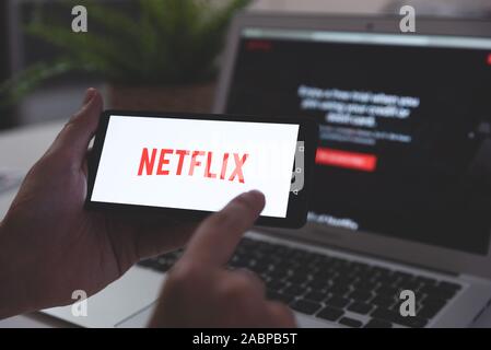 Wroclaw, Pologne - OCT 23, 2019 : l'homme avec Netflix logo sur écran. Netflix est plus populaire plate-forme de diffusion vidéo. Banque D'Images