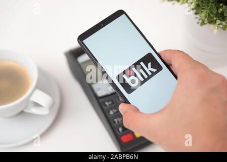 Wroclaw, Pologne - NOV 06, 2019 : Man holding smartphone avec Blik logo, le paiement sans contact. Blik est plus populaires polonais Méthode de paiement rapide en Pologne Banque D'Images