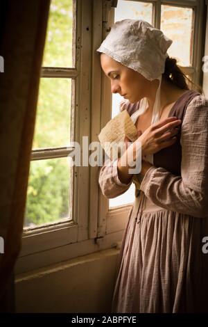 Style Vermeer portrait d'une jeune femme en costume renaissance la lecture d'une lettre à sa fenêtre Banque D'Images