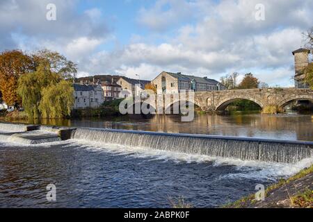 Stramongate Bridge sur la rivière Kent, Kendal, Cumbria, UK avec un déversoir à l'avant-plan et de bâtiments ou d'arbres dans le milieu/arrière-plan Banque D'Images