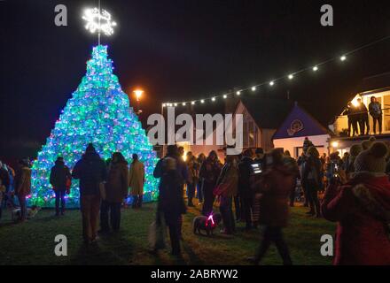 Les membres de la communauté d'examiner plus à fond les 16ft arbre de Noël sur le port-côte dans Ullapool, Wester Ross, qui est créé à partir de 340 à la nasse de pêche utilisés pour la capture de crevettes et crabes. Banque D'Images