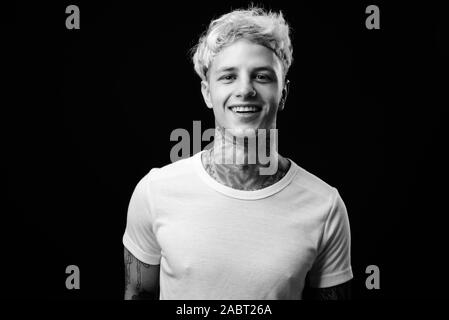 Beau jeune homme rebelle aux cheveux blonds en noir et blanc Banque D'Images