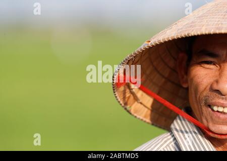 Farmer portant un chapeau conique traditionnel de la feuille de palmier. Portrait. Hoi An. Le Vietnam. Banque D'Images