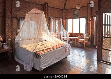 Une moustiquaire couvrant un lit à l'intérieur d'une cabane dans le lac Inle au Myanmar Banque D'Images
