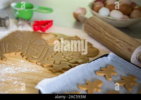 À l'aide d'un emporte-pièce en forme de Noël pour faire des biscuits de Noël au pain d'épices Banque D'Images