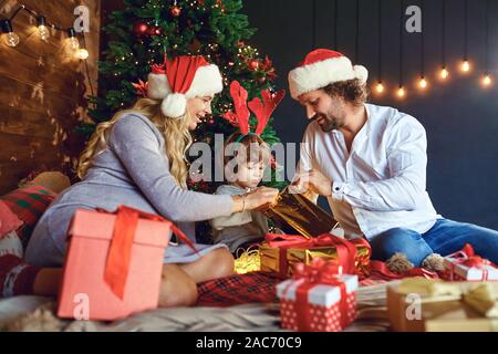 Famille de donner des cadeaux de Noël à la chambre Banque D'Images