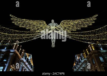 Lumières de Noël 2109 à Londres. L'esprit de lumières de Noël 2019, golden angel suspendue sur St James Street entre les bâtiments. Banque D'Images