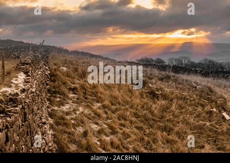 Régler le coucher du soleil à Winskill pierres près de Langcliffe dans le Yorkshire Dales. Banque D'Images