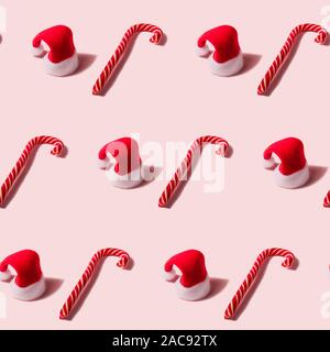 Noël à la mode seamless texture avec Santa Claus hat et Candy Cane. Noël moderne design. Banque D'Images