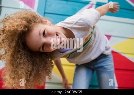 Fille devant un mur coloré Banque D'Images