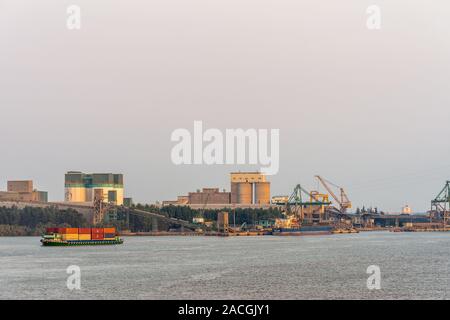 Phuoc Khanh, Vietnam - Mars 13, 2019 : sunset sky shot sur de longues Tau river. Bâtiments industriels avec les courroies de transport et de navires à quai et rvier cont Banque D'Images