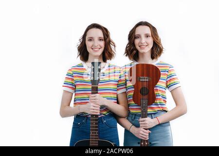 Deux soeurs jumelles avec des instruments de musique dans leurs mains. Banque D'Images