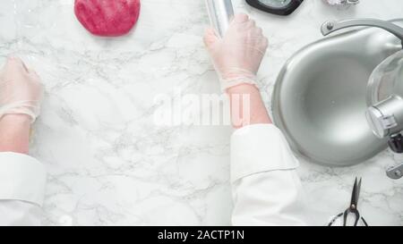 Étape par étape. Mise à plat. Le mélange colorant alimentaire dans la pâte à biscuits à cuire, rouge, blanc et bleu sucre pinwheel cookies. Banque D'Images