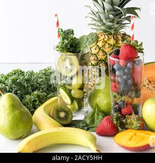 Une vue en gros plan de deux grands verres remplis de divers fruits et légumes utilisés pour faire des smoothies. Concept d'aliments sains. Banque D'Images