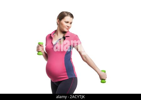 Jeune femme enceinte faire l'exercice avec les cloches sourdes-muettes Banque D'Images