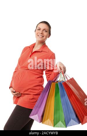 Pregnant woman holding shopping bags isolated Banque D'Images