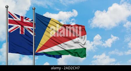 La NOUVELLE ZELANDE et les Seychelles drapeaux dans le vent contre ciel bleu nuageux blanc ensemble. Concept de diplomatie, de relations internationales. Banque D'Images