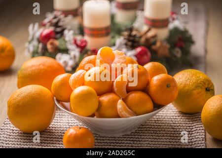 Mandarines et oranges sur table avec guirlande de noël Banque D'Images
