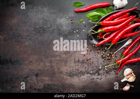 Red hot chili pepper corns et les gousses sur dark old metal background culinaire Banque D'Images