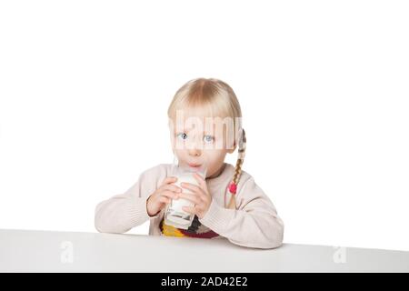 Portrait of a cute little girl boire du lait, isolated on white Banque D'Images