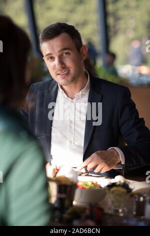 Closeup shot of young woman and man having meal. Banque D'Images