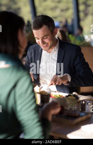 Closeup shot of young woman and man having meal. Banque D'Images