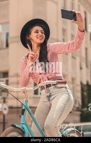 Pretty woman posing for sur le vélo selfies stock photo Banque D'Images