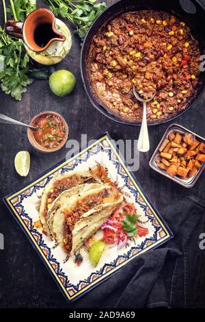 Mijotés traditionnels Mexican chili con canne avec vue de dessus comme les tortillas sur une plaque de couleur Banque D'Images