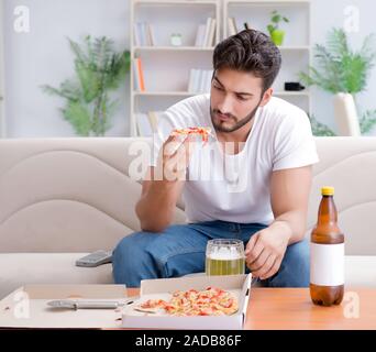 Man eating pizza à emporter à la maison avoir un repos relaxant Banque D'Images