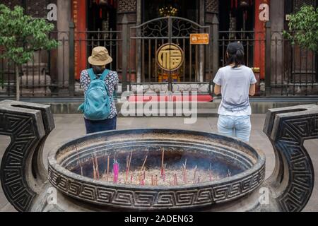 Chengdu, Chine - Juillet 2019 : femme chinoise et l'homme en prière, l'adoration, la combustion d'encens, l'aumône et grâce à la bouddhiste chinois Wenshu Banque D'Images