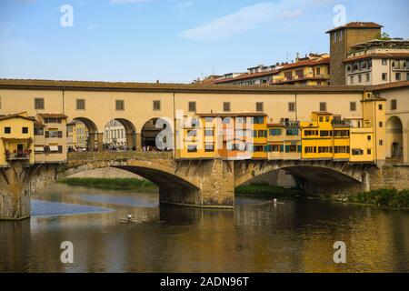 Sur le célèbre Ponte Vecchio dans le centre historique de Florence, l'Unesco W.H. Site, avec deux hommes de l'aviron sur la rivière Arno, Toscane, Italie Banque D'Images