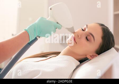 Close up of woman et boucher l'épilation au laser Banque D'Images