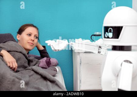 Robot médecine aide une patiente, travaillant comme aide familiale, donnant un mouchoir Banque D'Images