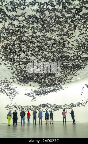 Personnes regardant 10 000 oiseaux Murmuration porcelaine suspendu (Paysage) installation à la National Gallery of Victoria NGV Melbourne Australie. Banque D'Images