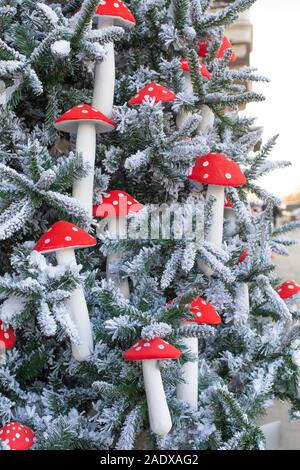 La décoration du Nouvel An, à la verticale. L'épinette et les décorations artificielles eco dans l'agaric fly. Bel arbre de Noël avec de la neige sur les branches et Banque D'Images