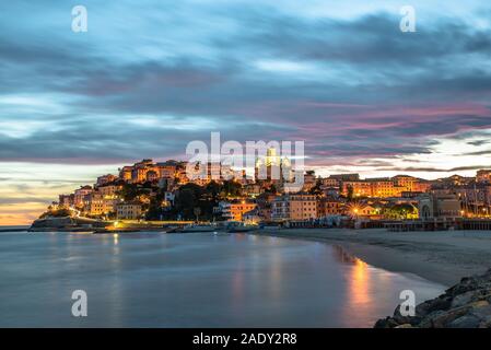 Spettacolare tramonto sul piccolo villaggio di Porto Maurizio (Imperia) costruito su una collina che si affaccia sul Mar Ligure Banque D'Images