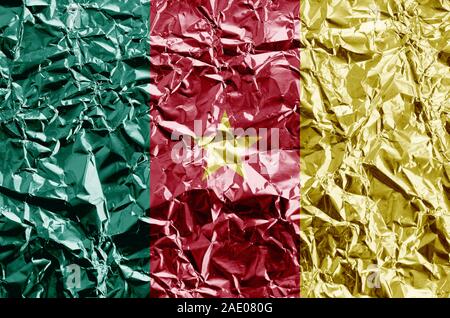 Drapeau Cameroun représenté dans des couleurs de peinture sur aluminium froissé brillant close up. Bannière sur fond rugueux texturé Banque D'Images