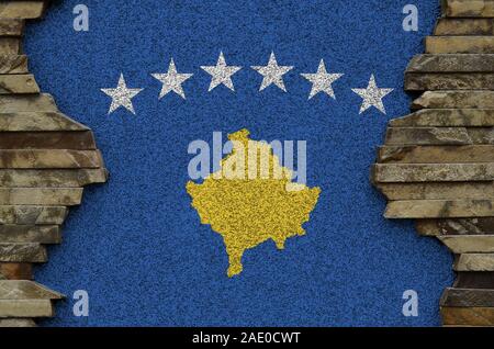 Drapeau du Kosovo représentés dans des couleurs de peinture sur vieux mur de pierre close up. Bannière texturé sur rock wall background Banque D'Images