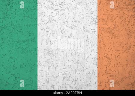 Drapeau Irlande représentée dans des couleurs de peinture sur vieux mur plâtrage secours close up. Bannière sur fond rugueux texturé Banque D'Images