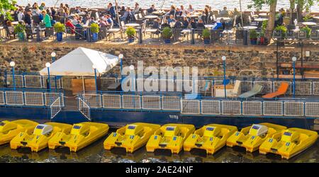 Klub Lávka pédale en plastique jaune bateaux à louer à pagayer sur la rivière Vltava et manger en plein air et de boire Prague Praha République Tchèque Banque D'Images