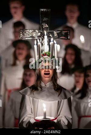 Matilda Bergstrom portant une couronne de bougies symbolisant St Lucy, conduit une procession aux chandelles du choeur nordique au cours de la London Sankta Lucia service à York Minster. Photo date : vendredi 6 décembre 2019. Le service suédois de l'atmosphère est une célébration de Sainte Lucie, une fille sicilien martyrisé pour sa foi chrétienne au quatrième siècle. La couronne symbolise un halo, une écharpe rouge son martyre, et le service célèbre l'occasion de l'entrée de la lumière au cours de l'obscurité de l'hiver. Crédit photo doit se lire : Danny Lawson/PA Wire Banque D'Images