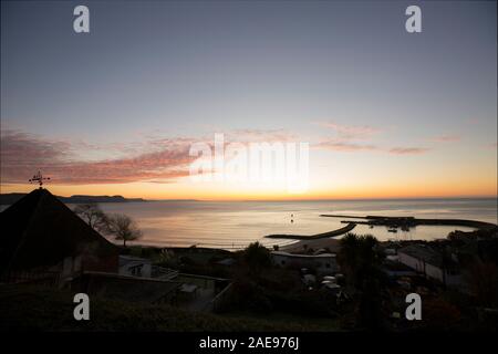 Une vue de Lyme Regis Harbour au lever du soleil sur un matin glacial au début de décembre 2019. Lyme Regis est situé sur la côte du patrimoine ou jurassi Banque D'Images