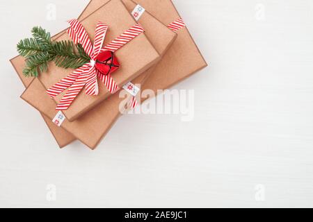 Cadeaux de Noël sapin décoré les branches d'arbres et des cloches sur fond blanc Banque D'Images