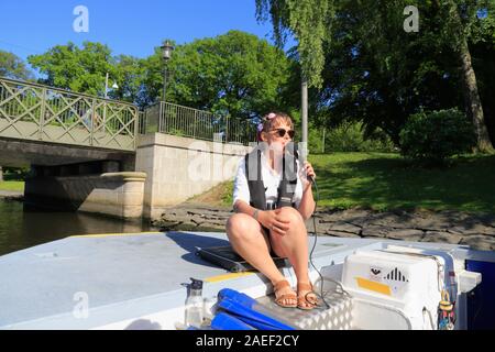 Un guide parle dans un microphone et fournit des informations aux touristes sur les bateaux Paddan à Göteborg, en Suède, au cours de l'été. Banque D'Images