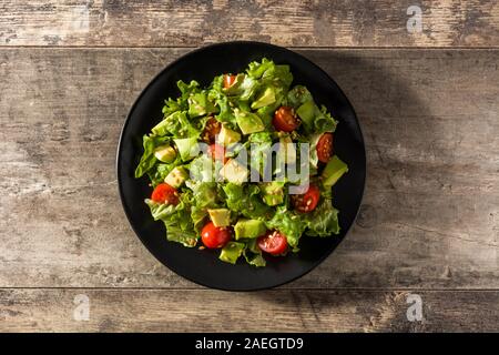 À l'avocat salade, laitue, tomate, les graines sur table en bois. Vue d'en haut Banque D'Images