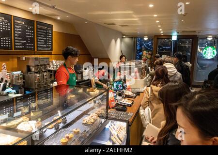 Les clients d'attente dans magasin Starbucks, Ginza, Tokyo, Japon Banque D'Images