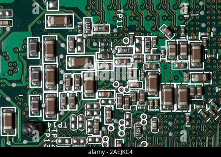 Vue détaillée des composants électroniques sur une carte de circuit imprimé verte utilisée dans les appareils électroniques modernes Banque D'Images